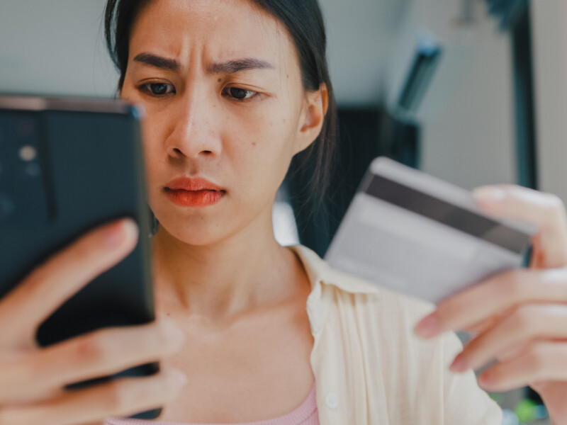 Woman looking at fraudulent activity on her banking mobile app.