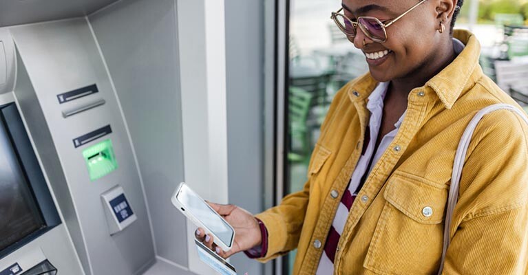 A woman using an ATM.