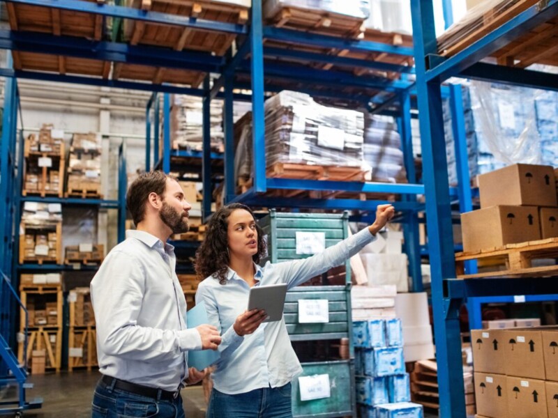 Man and woman in a warehouse.