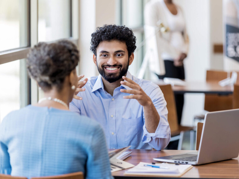 Man speaking to a businsesswoman.