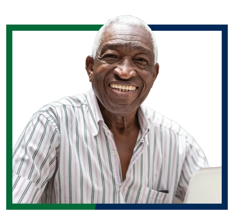 Smiling older man using a laptop to open an IRA CD.