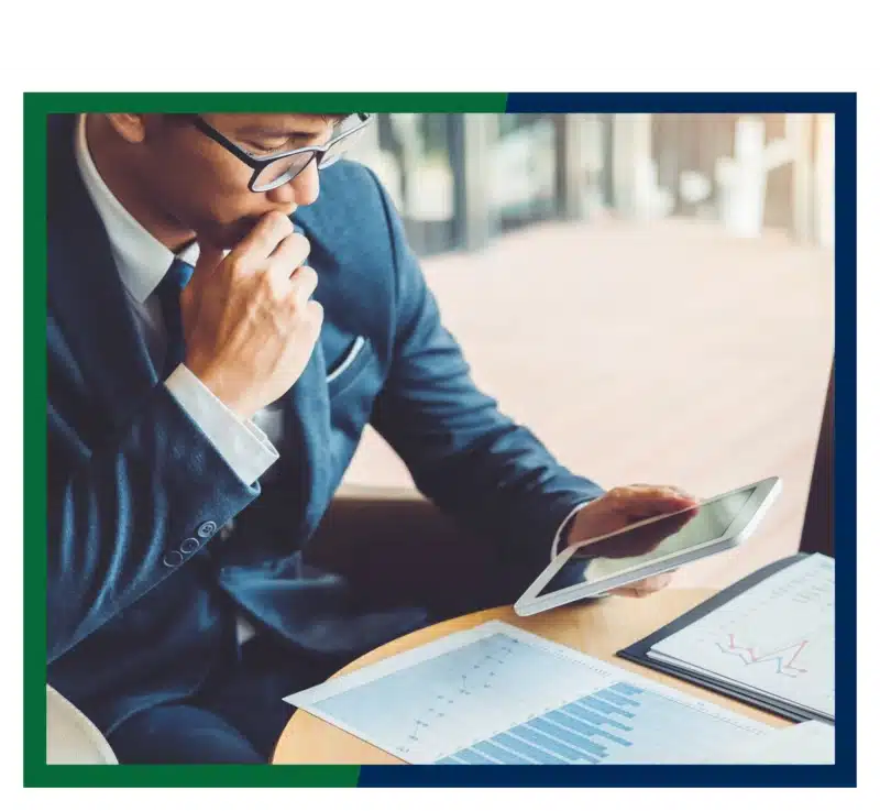 A businessman looking at charts and graphs.