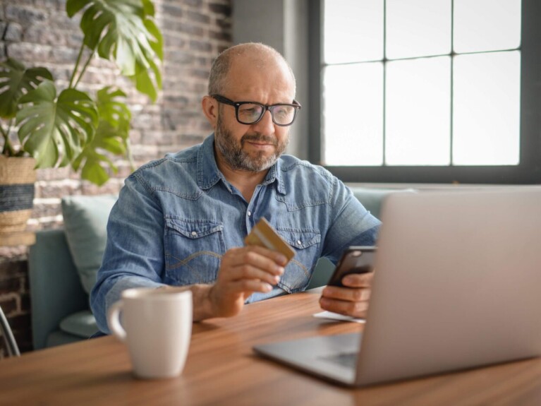 Man browsing business checking accounts on his laptop.