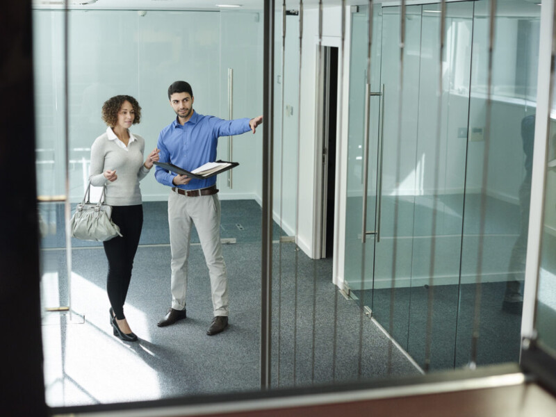 A real estate agent showing a commercial office space.