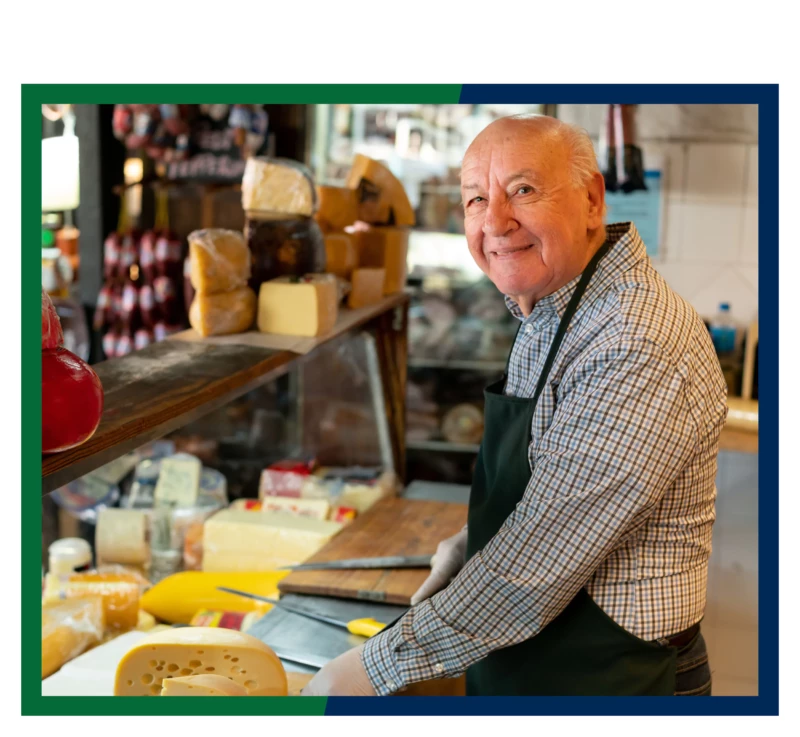 A man working behind the counter at a deli.