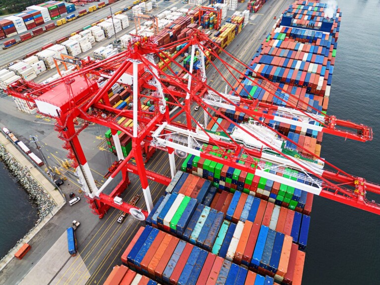 Shipping containers and cranes at a port.