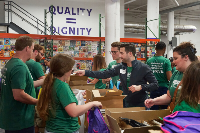 Group of WSFS associates volunteering, packing school supplies.