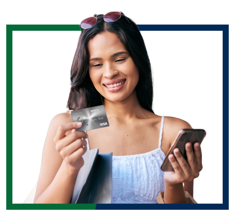 A woman holding WSFS Cash Back credit card.