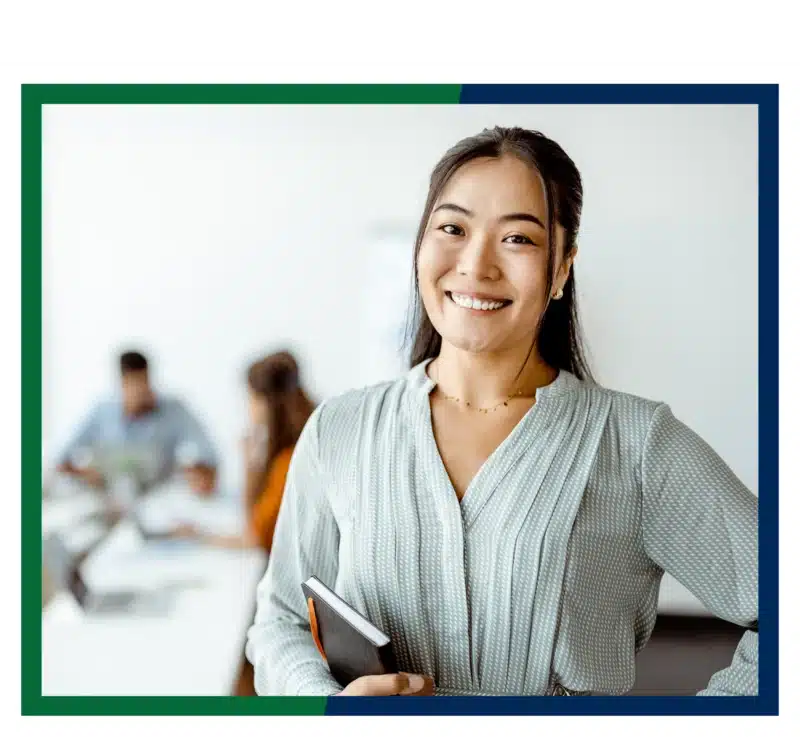 A woman holding a notebook.
