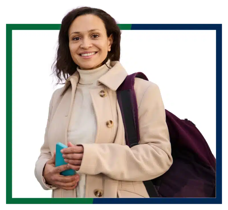 Woman with backpack in front of airplane times.