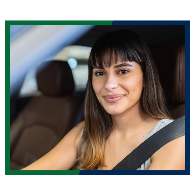 A woman in the driver's seat of a car.